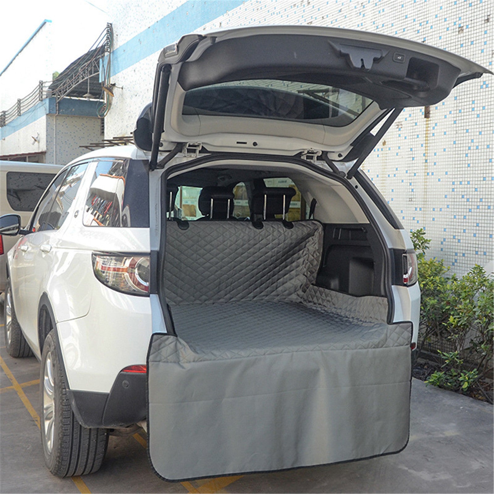 Waterproof pet car trunk mats by CJ, durable and cushioned for pets, designed to protect car interior during travel.