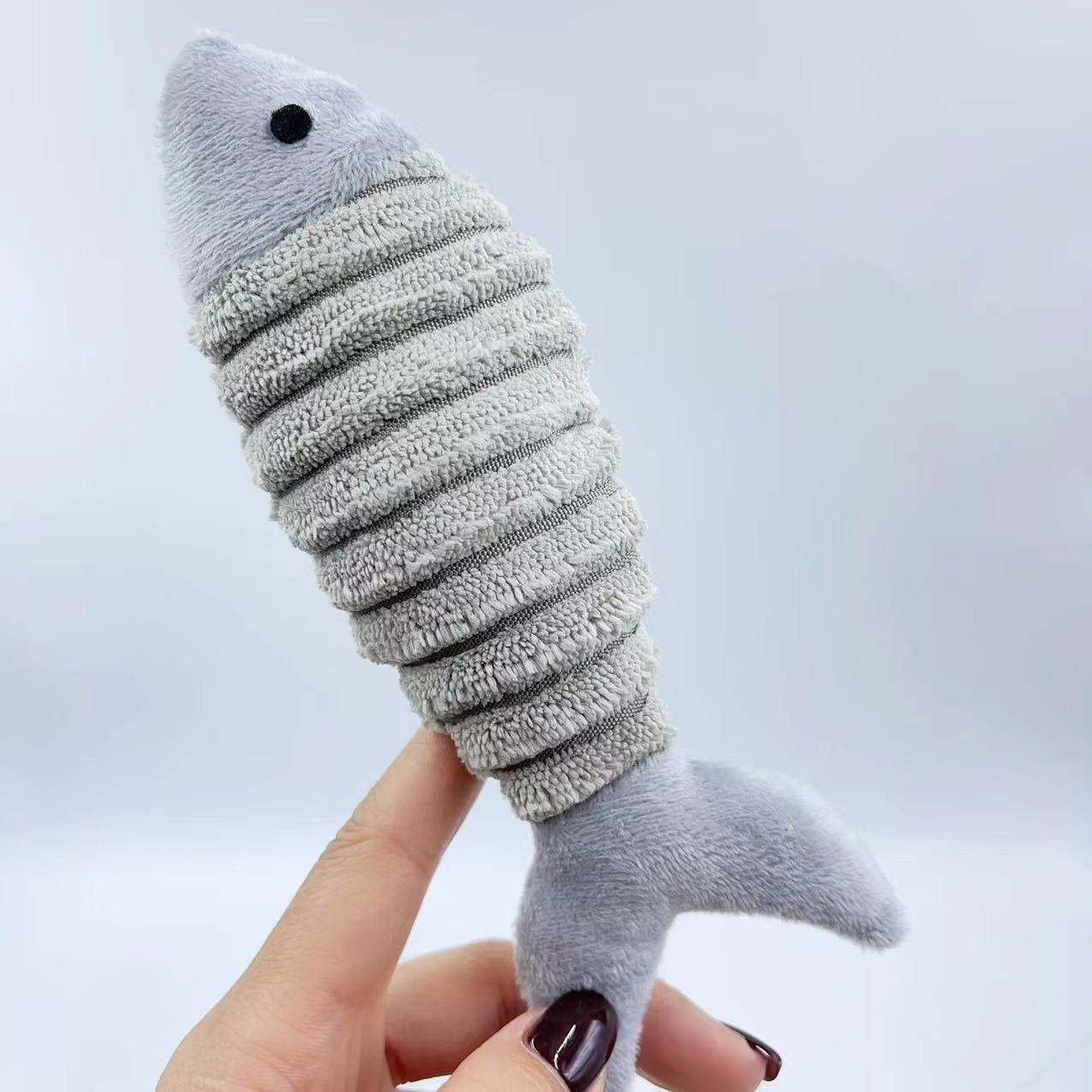 CJ plush catnip fish toy for cats, soft and colorful with a fish design, perfect for pet play and entertainment.